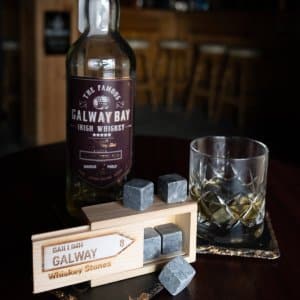 Set of whiskey stones in a wooden box engraved with a road sign saying Galway
