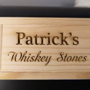 Set of whiskey stones in wooden box with person's name engraved on it